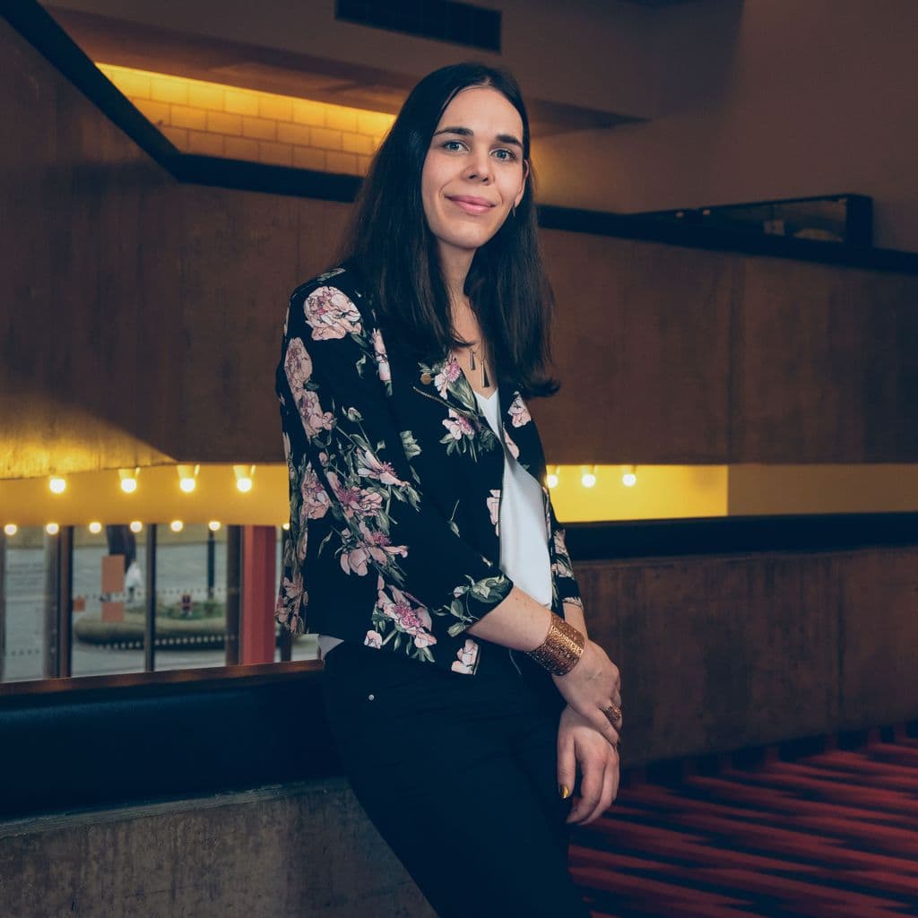 Chris Bush standing in the foyer of the NT auditorium