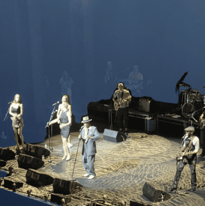 light blue background with a band on the stage